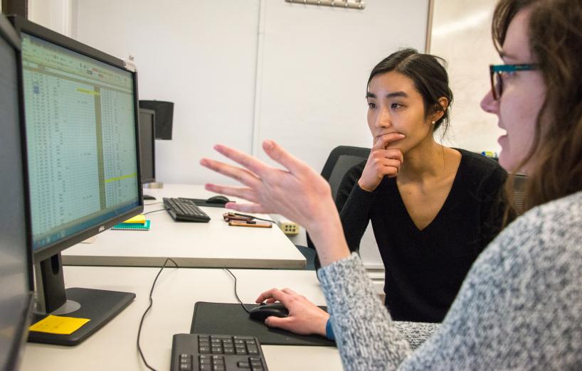 Graduate students in a Psychology lab discuss recent study data.